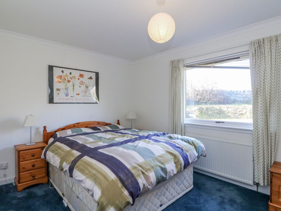 A bedroom with a bed and window at Grianach in Balnaguard near Strathtay