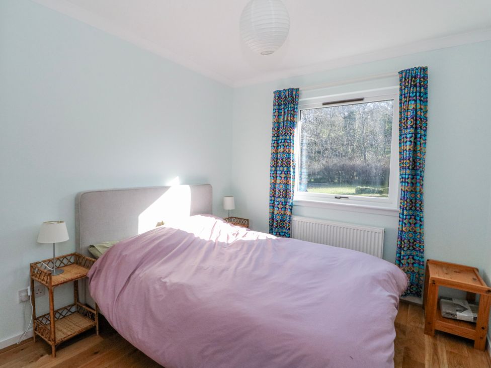 A bedroom with a bed and side tables at Grianach Balnaguard near Strathtay