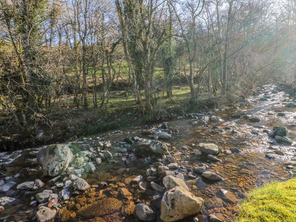 A stream flowing through a forested area at Grianach in Balnaguard near Strathtay