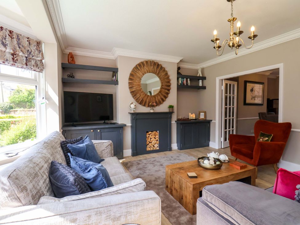 A living room with a sofa and television at 16 High Street