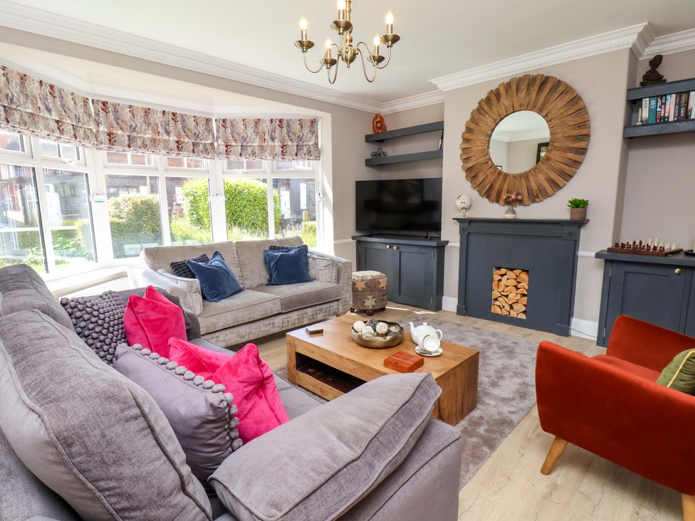 A living room with a coffee table and sofa at 16 High Street