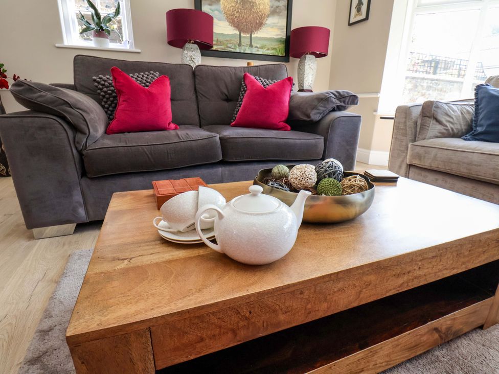 A living room with a sofa and coffee table at 16 High Street