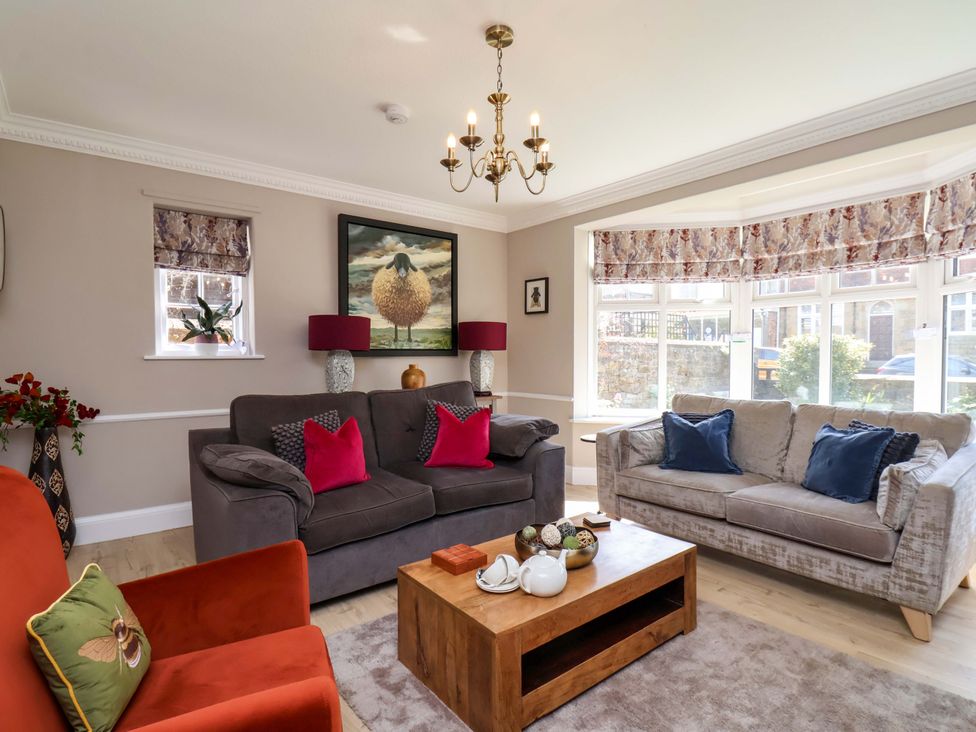 A living room with a sofa and coffee table at 16 High Street
