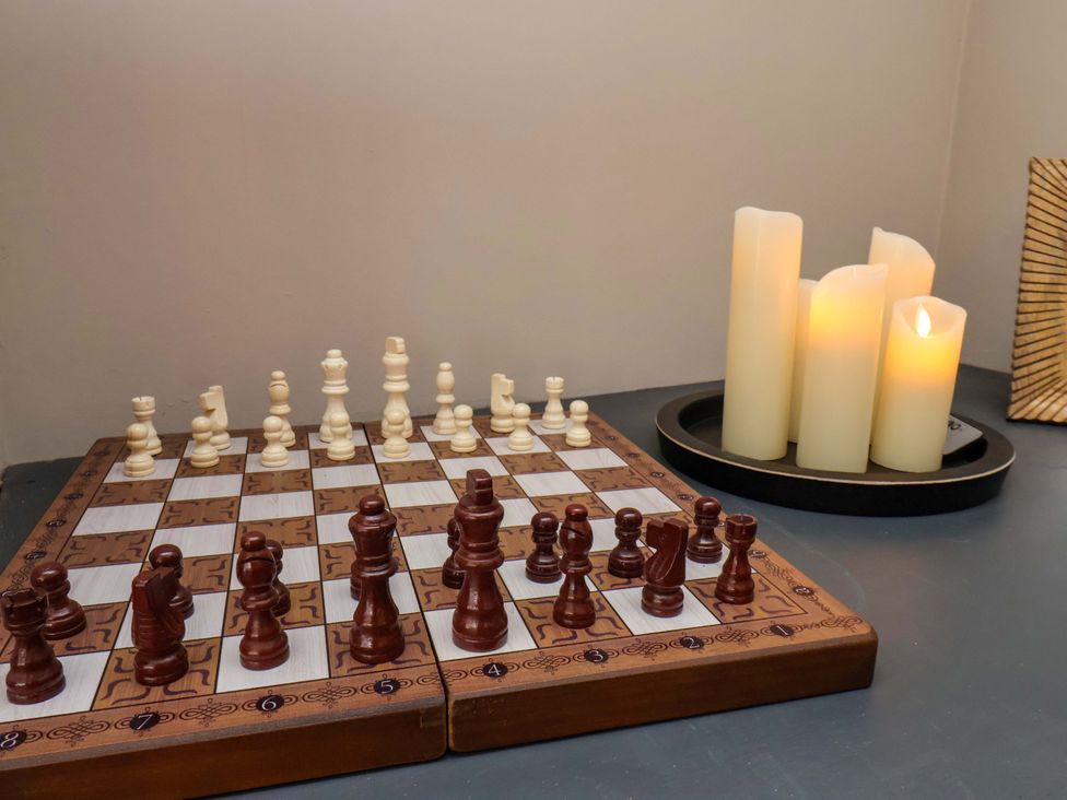 A chessboard with chess pieces and candles at 16 High Street