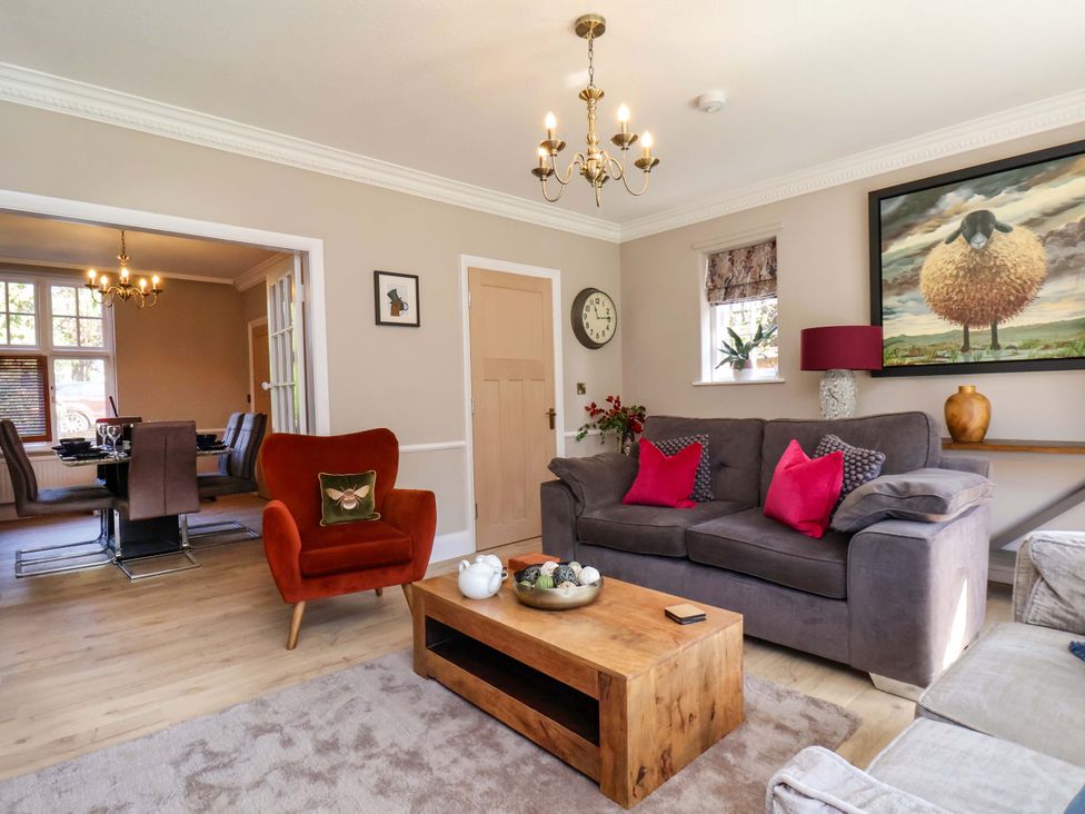 A living room with brown sofa and armchair at 16 High Street