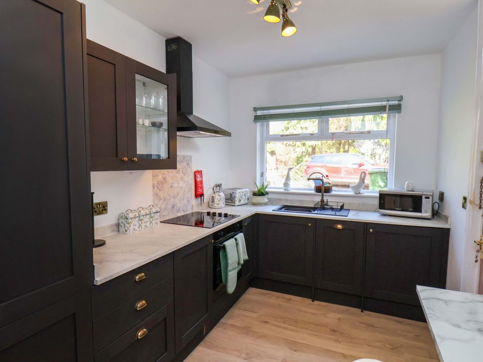A kitchen with black cabinets and a window at 16 High Street