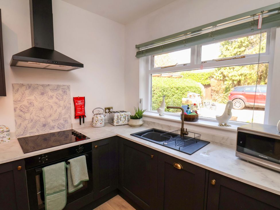 A kitchen with a stove and sink at 16 High Street