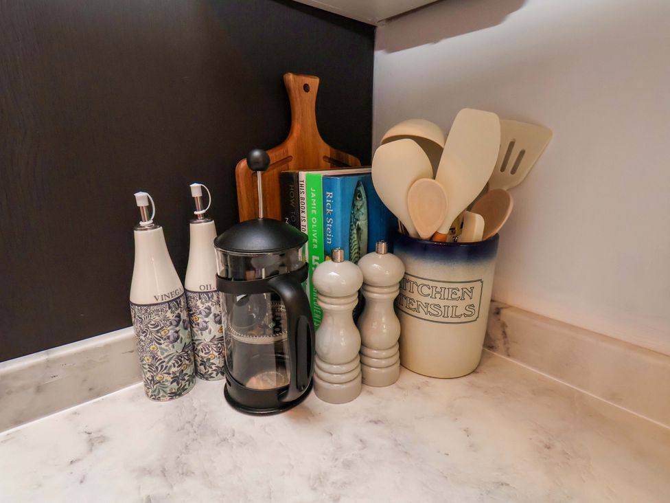 Kitchen counter with salt and pepper shakers, vinegar and oil bottles, and kitchen utensils at 16 High Street