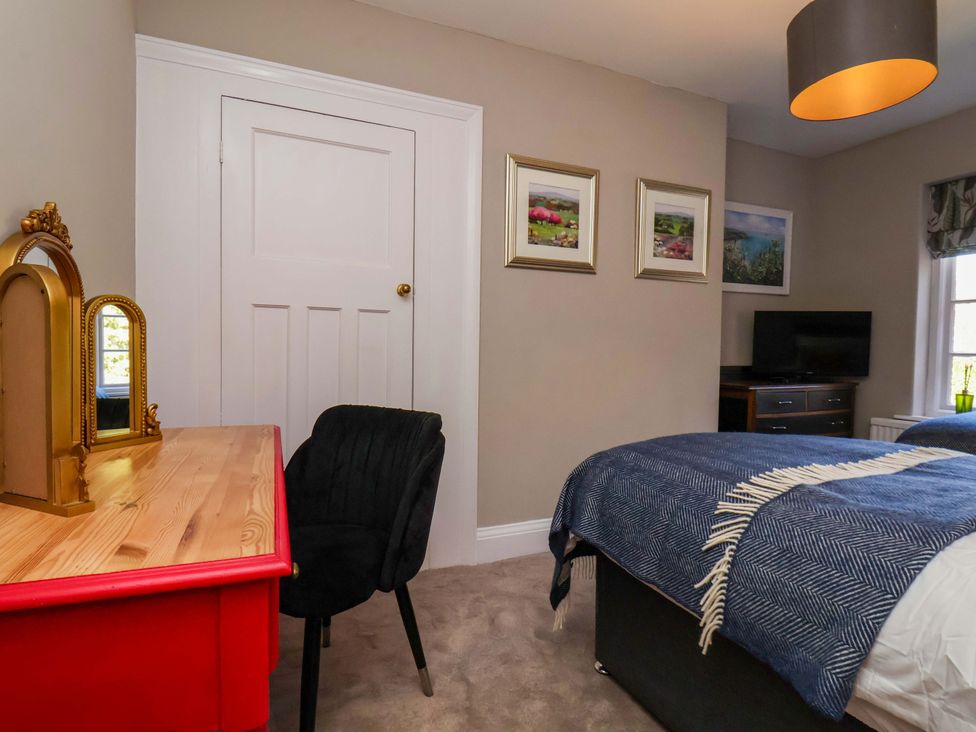 A bedroom with a bed and desk at 16 High Street