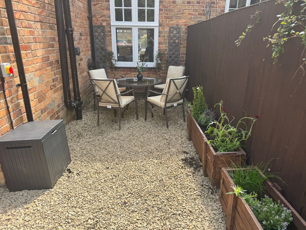 A garden area with chairs and a table at 16 High Street Scalby