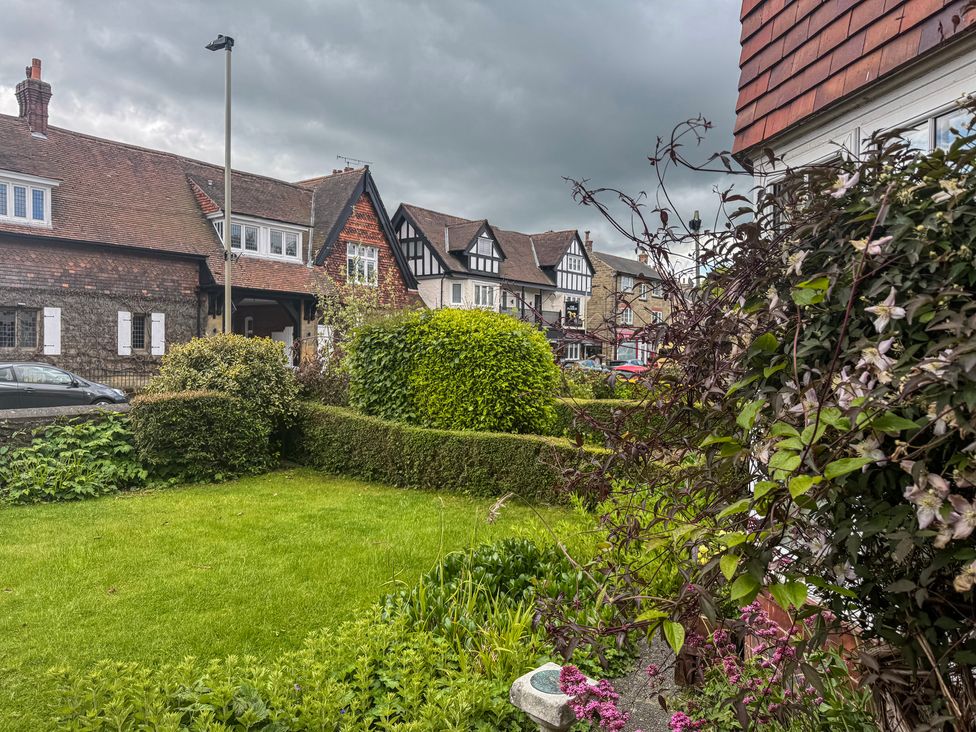 A garden with hedges and houses in the background at 16 High Street Scalby