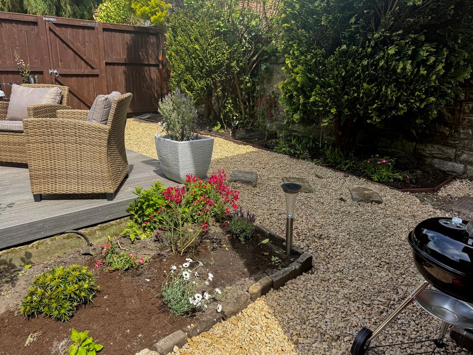 A garden with seating area and barbecue at 16 High Street Scalby