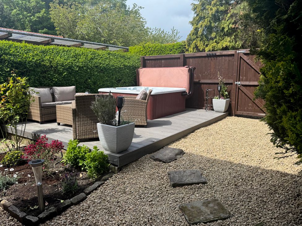 A garden with a hot tub and outdoor seating at 16 High Street Scalby