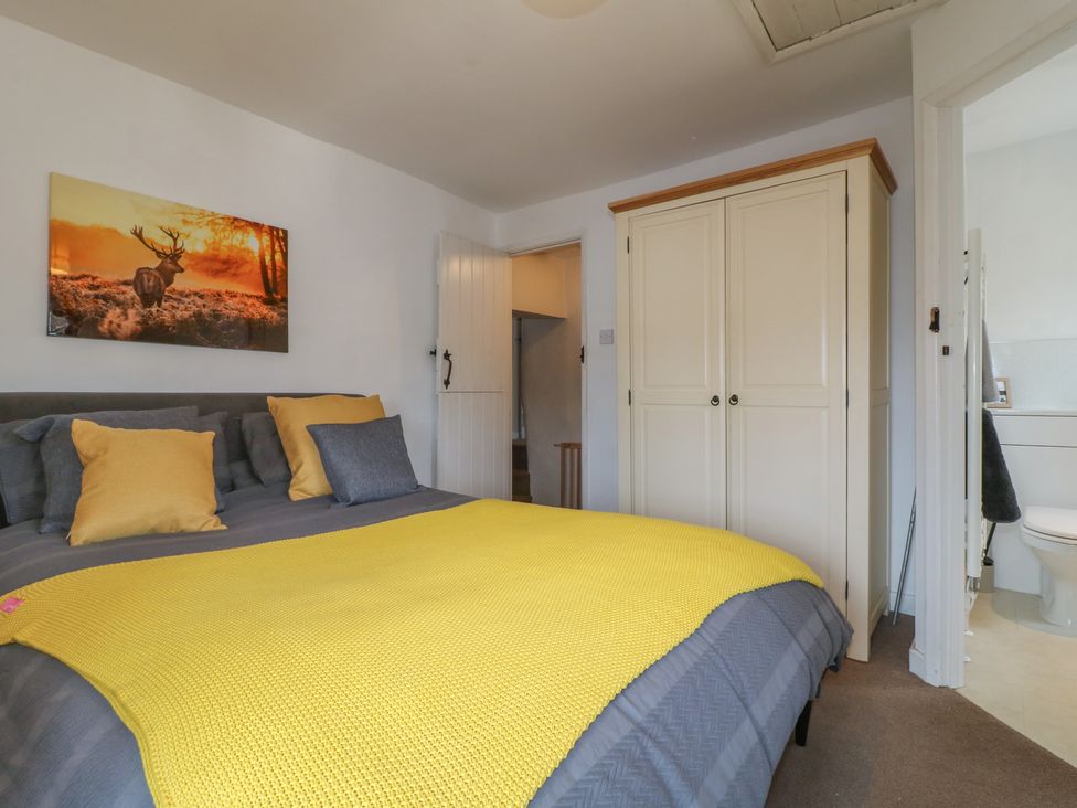 A bedroom with a bed and wardrobe at Blindwell House
