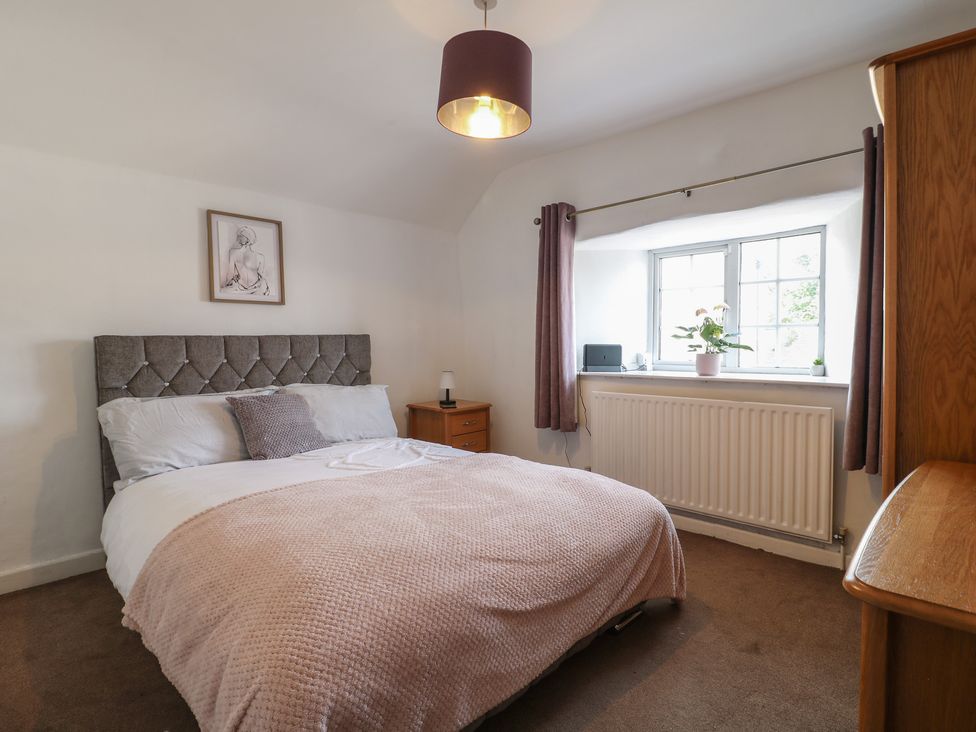 A bedroom with a bed and window at Blindwell House