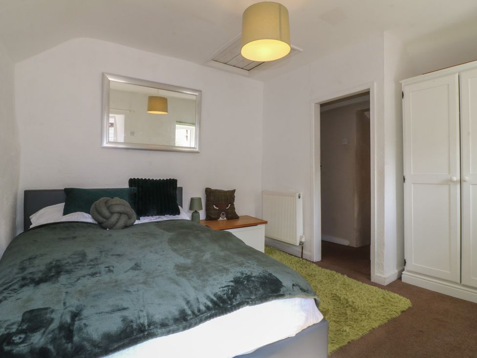 A bedroom with a bed and wardrobe at Blindwell House
