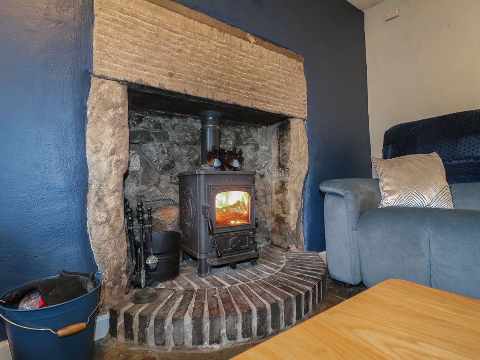 A living room with a fireplace and a sofa at Blindwell House