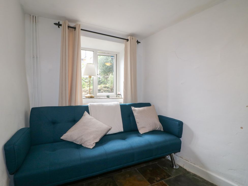 A sofa with cushions and a window at Blindwell House