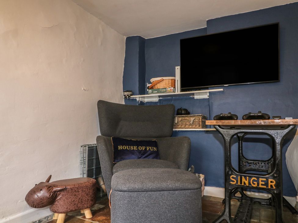A snug with seating and gaming setup at Blindwell House