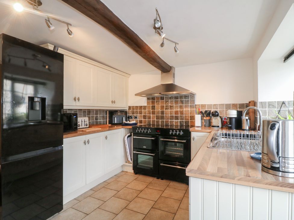 A kitchen with cabinets, oven, stove, sink and appliances at Blindwell House