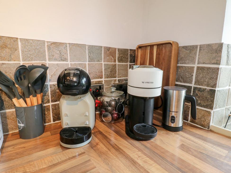A kitchen with coffee maker and utensils at Blindwell House 