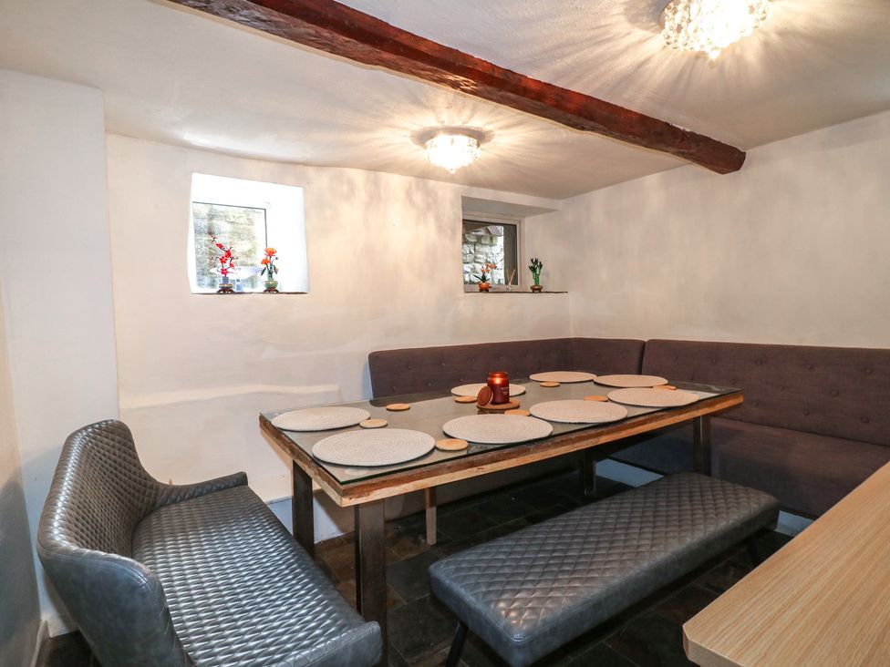 A dining room with a table and benches at Blindwell House