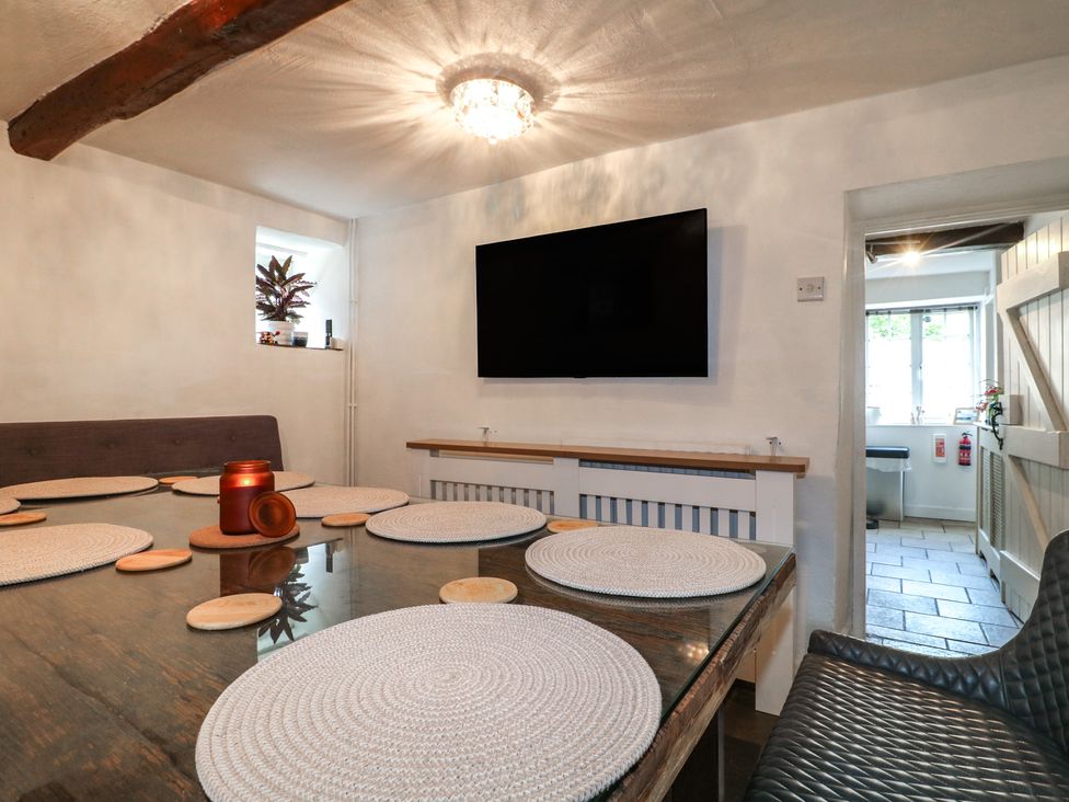 A dining room with a table and TV at Blindwell House