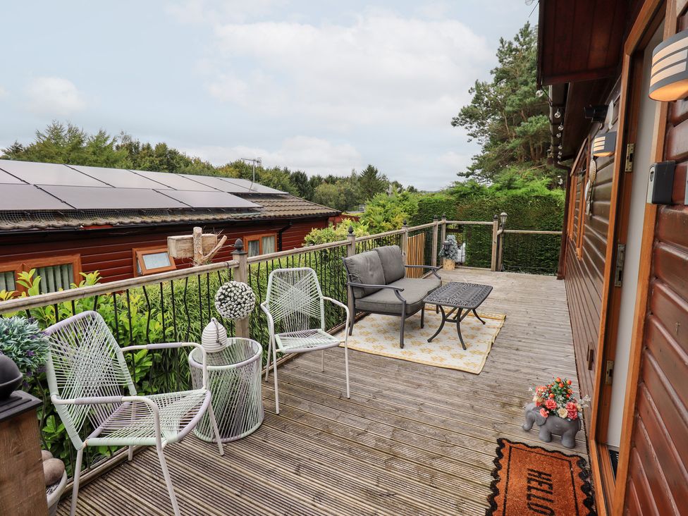 An outdoor seating area with chairs and table at Charnwood
