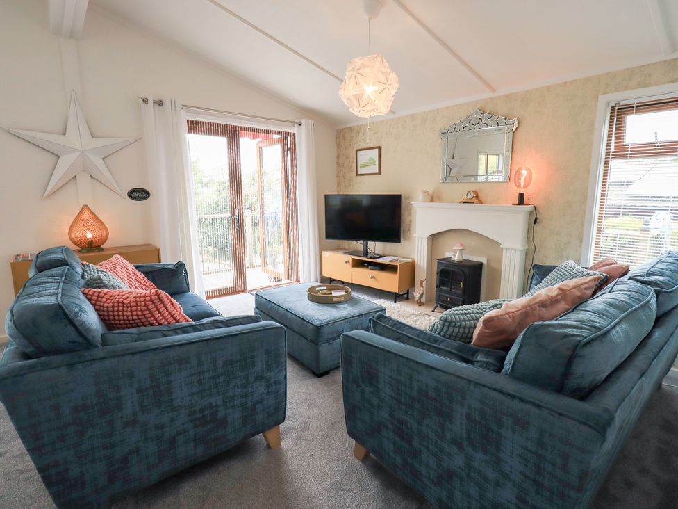 A living room with seating and a television at Charnwood