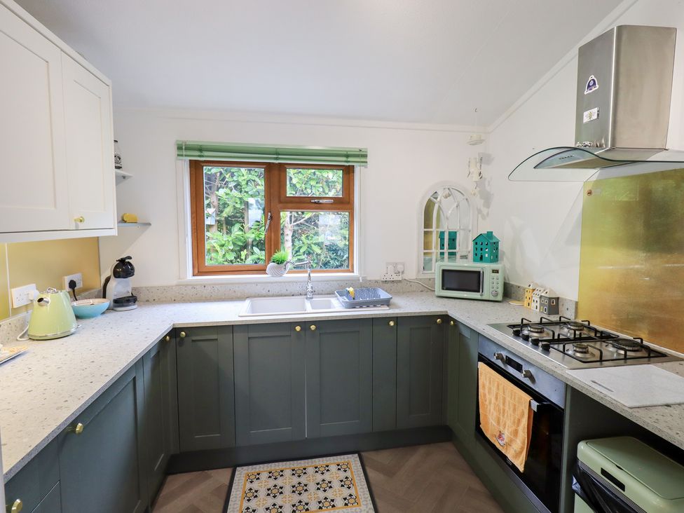 A kitchen with a sink and window at Charnwood