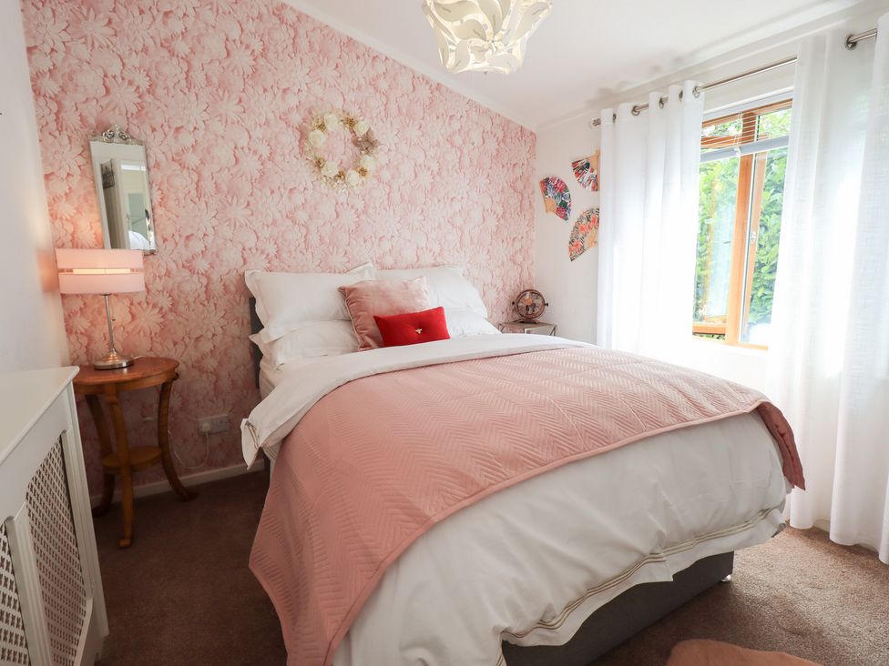 A bedroom with a bed and decorative items at Charnwood