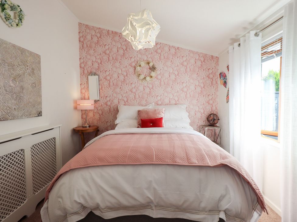 A bedroom with a bed and lamp at Charnwood