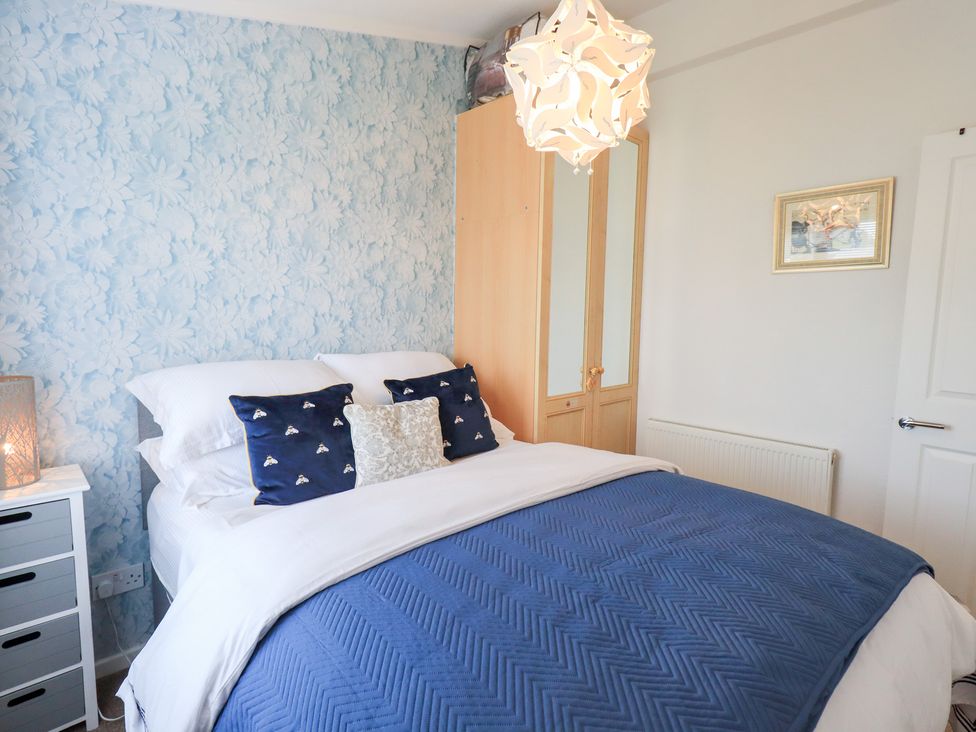A bedroom with a bed and wardrobe at Charnwood