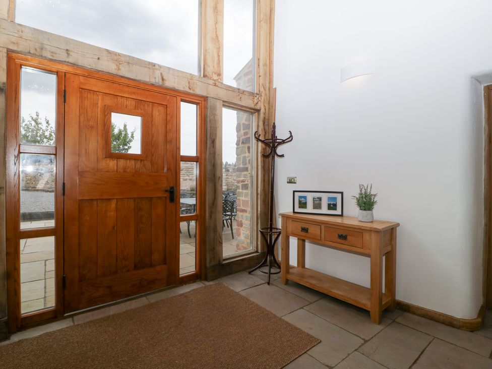 An entrance hall with a front door and a console table at Two Parks Barn Upton Bishop near Ross-On-Wye