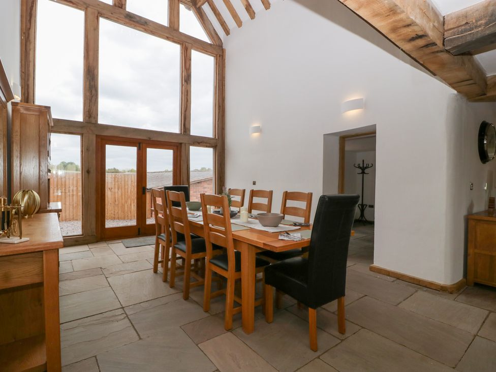 A dining room with a large table and chairs at Two Parks Barn Upton Bishop near Ross-On-Wye