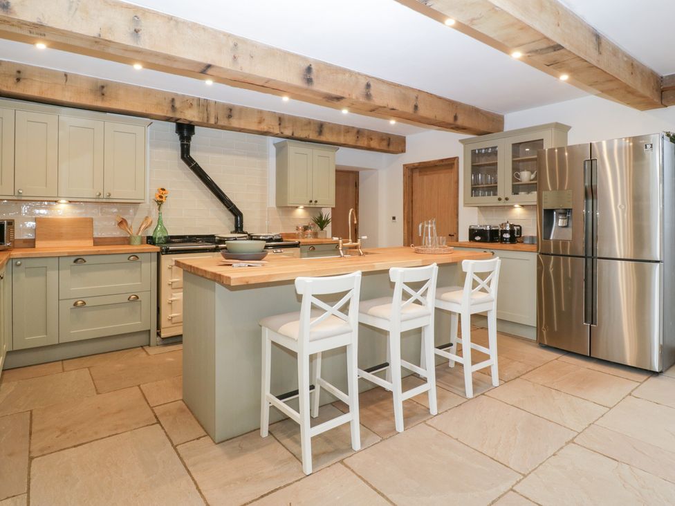 A kitchen with a refrigerator and stove at Two Parks Barn Upton Bishop near Ross-On-Wye