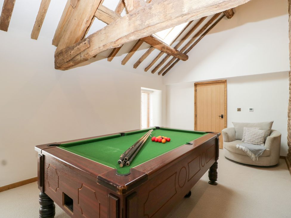 A games room with a pool table and a chair at Two Parks Barn Upton Bishop near Ross-On-Wye