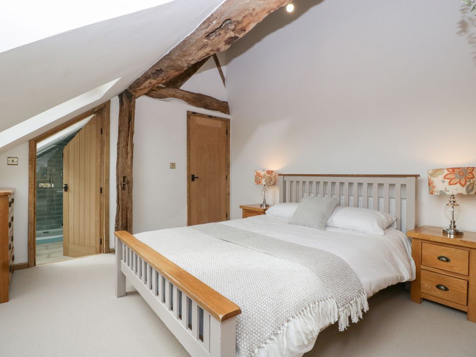 A bedroom with a bed and nightstands at Two Parks Barn Upton Bishop near Ross-On-Wye
