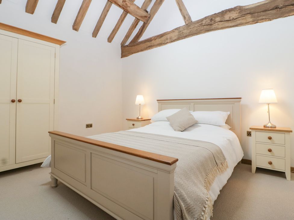 A bedroom with a bed and side tables at Two Parks Barn Upton Bishop near Ross-On-Wye