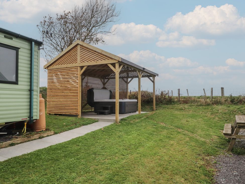 An outdoor area with a shelter and hot tub at Bryncrin Edern near Morfa Nefyn