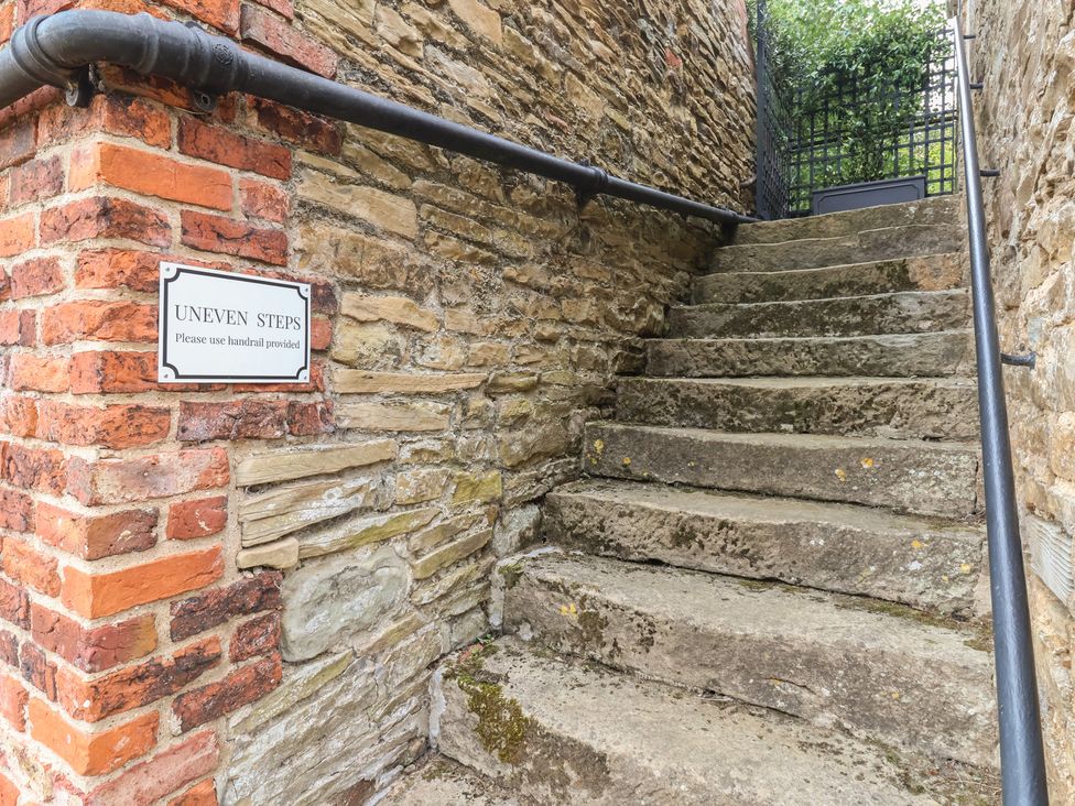 An outdoor staircase with uneven steps and a handrail at The Annex at Manor Farm