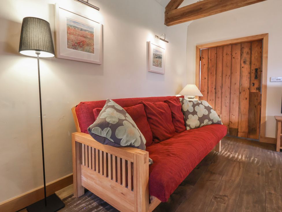 A living room with a sofa and lamp at The Annex at Manor Farm