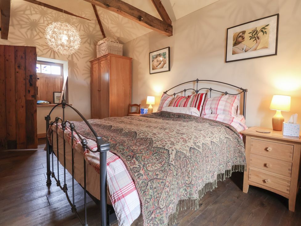 A bedroom with a bed and bedside table at The Annex at Manor Farm