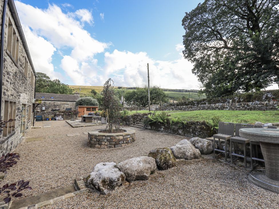 An outdoor area with seating and a fire pit at Hallbeck near Kettlewell