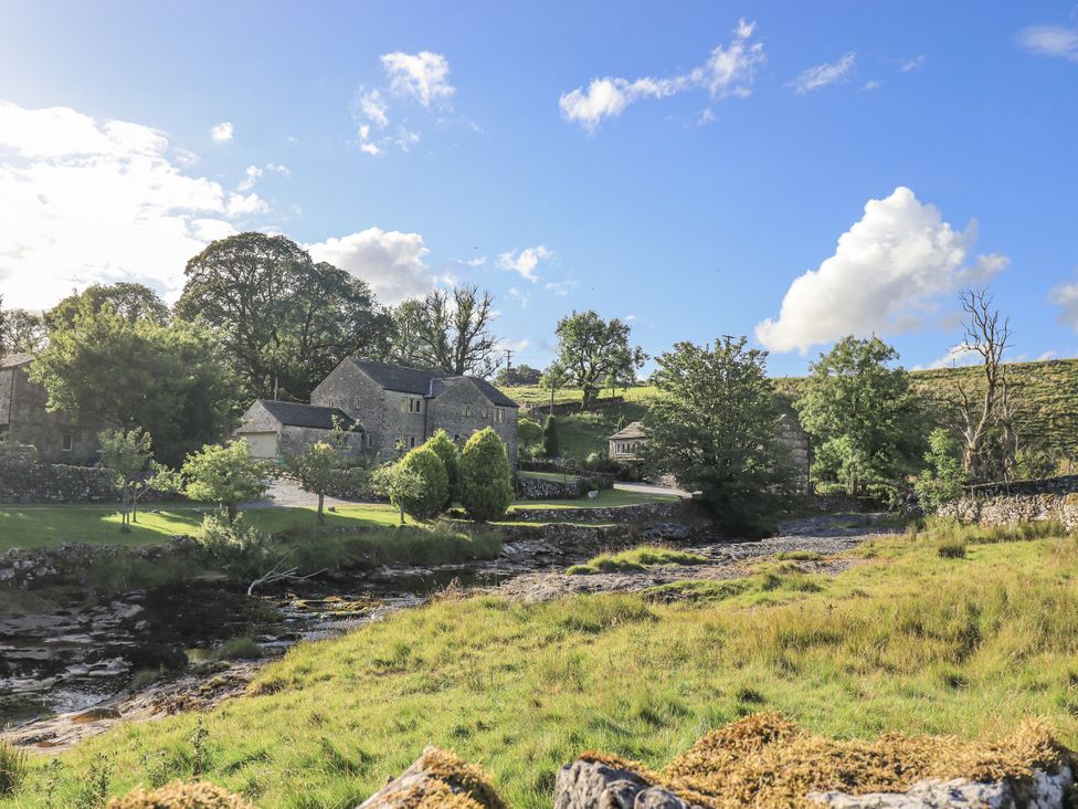 A landscape view with buildings and trees at Hallbeck near Kettlewell