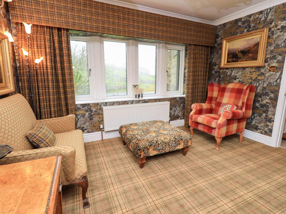 A snug with a sofa and armchair at Hallbeck in Buckden