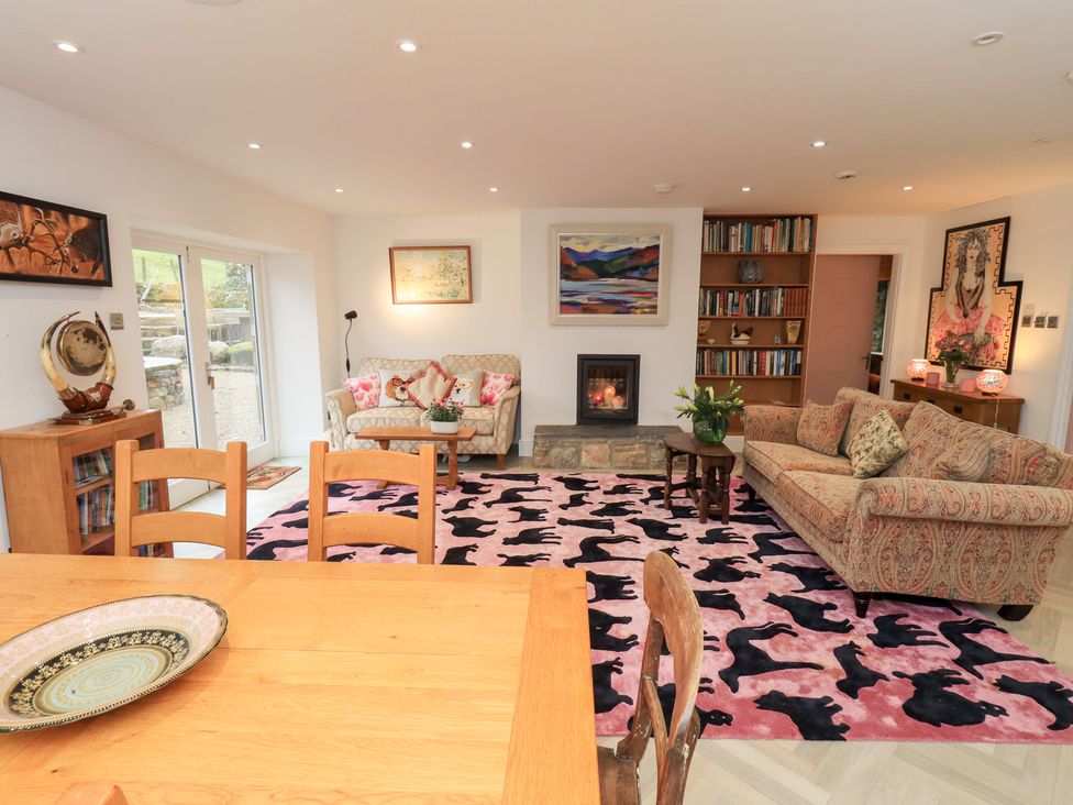 A living room with a sofa and fireplace at Hallbeck in Buckden