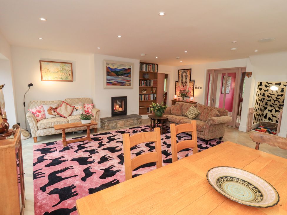 A living room with a fireplace and seating area at Hallbeck in Buckden