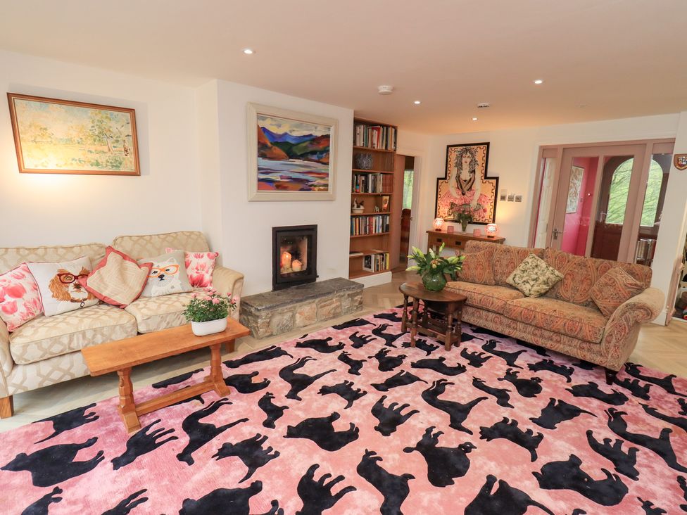 A living room with a sofa and fireplace at Hallbeck in Buckden