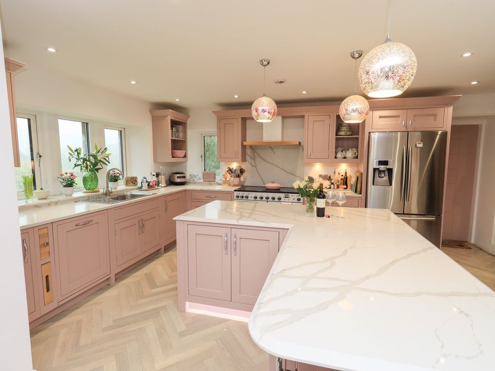 A kitchen with cabinets and an island at Hallbeck in Buckden